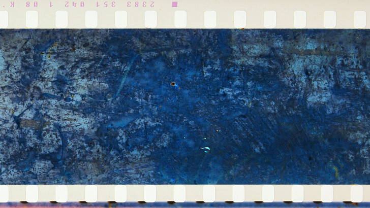 A film strip shows an aerial shot of a rocky landscape