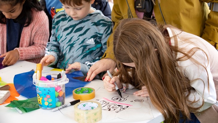 Children drawing together at a table