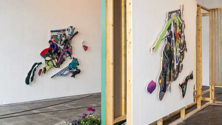 A gallery installation including two irregularly shaped paintings