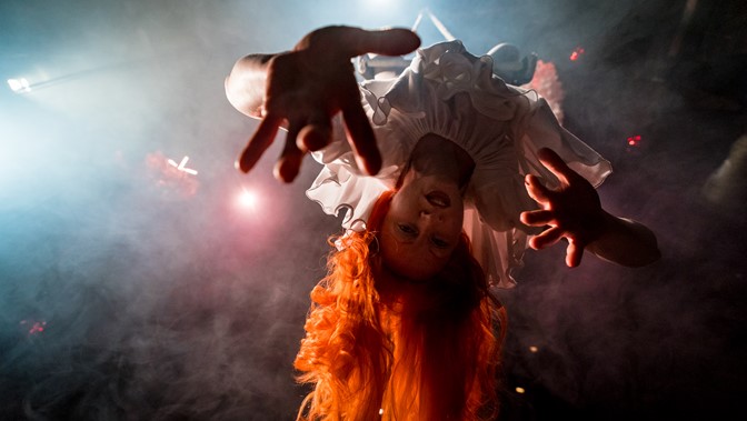 Performer Vee Smith pictured from below, hanging upside down 